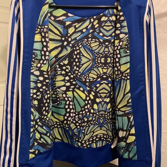 A blue Adidas jacket with butterfly design on the inside of the jacket. - Picture 2 of 2